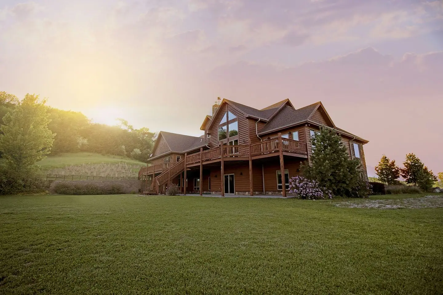 Large American home with a completed residential roof, photographed in late-afternoon light